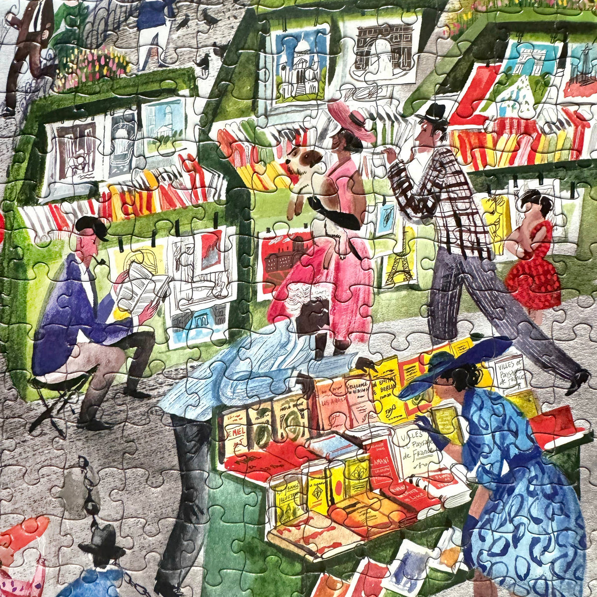 Completed Paris Bookseller 1000 piece jigsaw puzzle by eeboo showcasing a bustling city scene and details