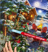 Completed Christmas Cabin puzzle by Springbok with peaceful winter landscape and crackling fire