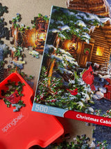 Close-up of Christmas Cabin puzzle pieces by Springbok with tranquil cabin and snowy details a 500 piece puzzle