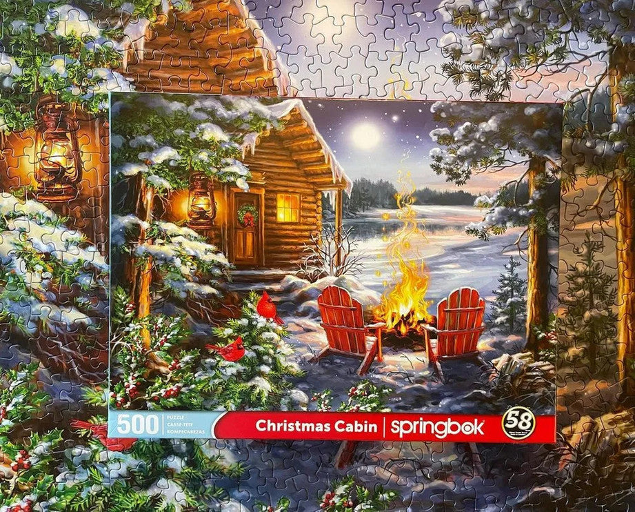 High-quality 500 piece jigsaw puzzle featuring a cozy Christmas cabin scene by Springbok