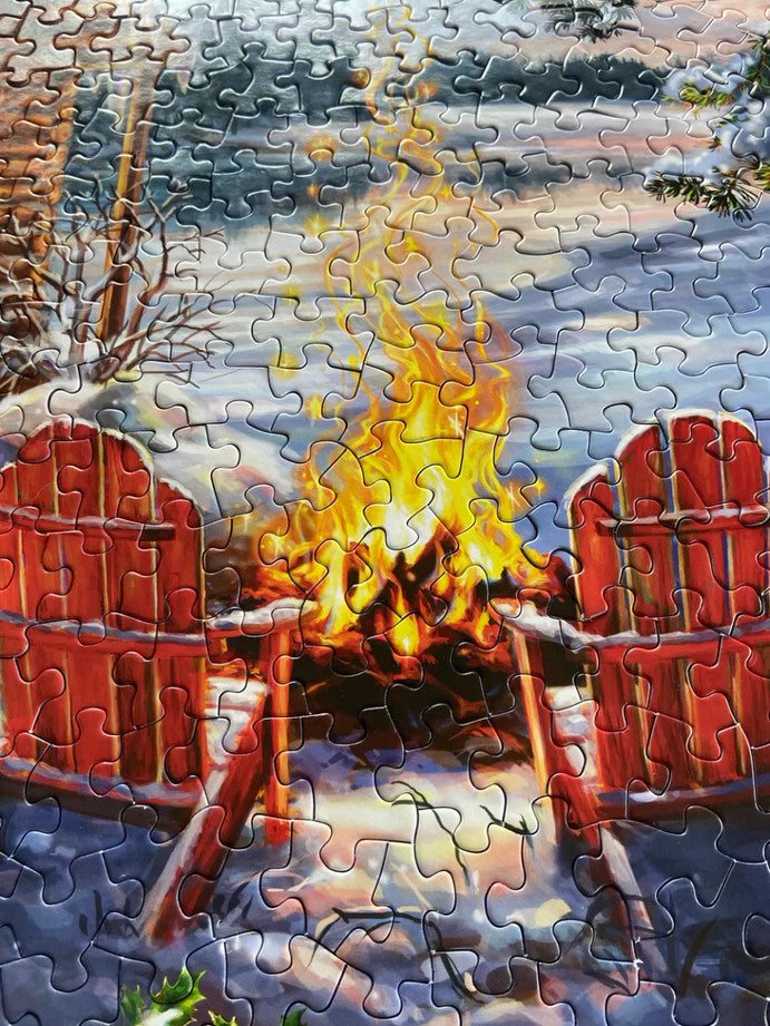 Close-up of Christmas Cabin puzzle pieces with tranquil cabin and snowy details