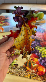 Close-up of Harvest Cornucopia puzzle pieces with rich autumn colors and harvest details by Springbok Puzzles