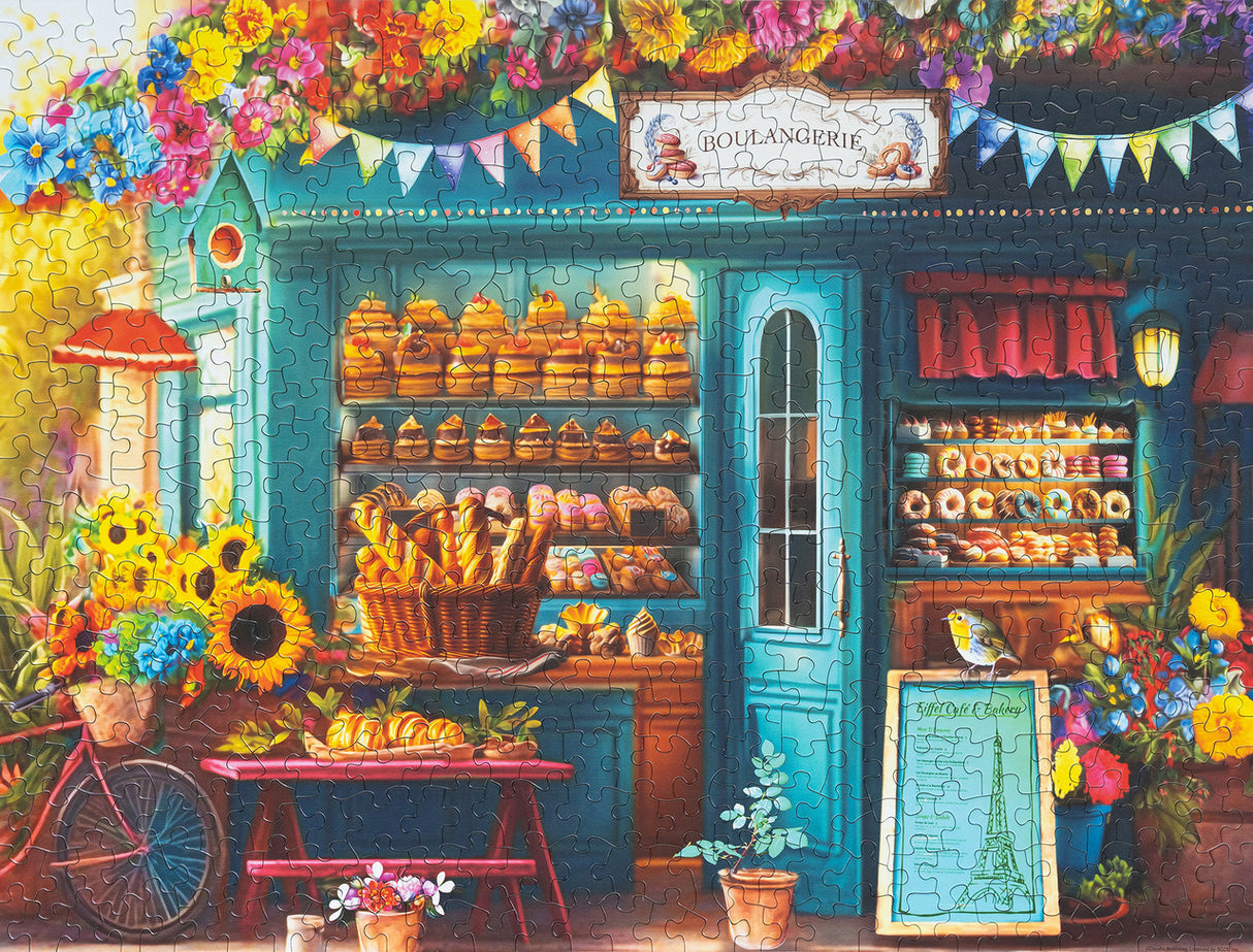 Illustration of a quaint Parisian pastry shop with detailed displays of baked goods, perfect for Springbok puzzle fans