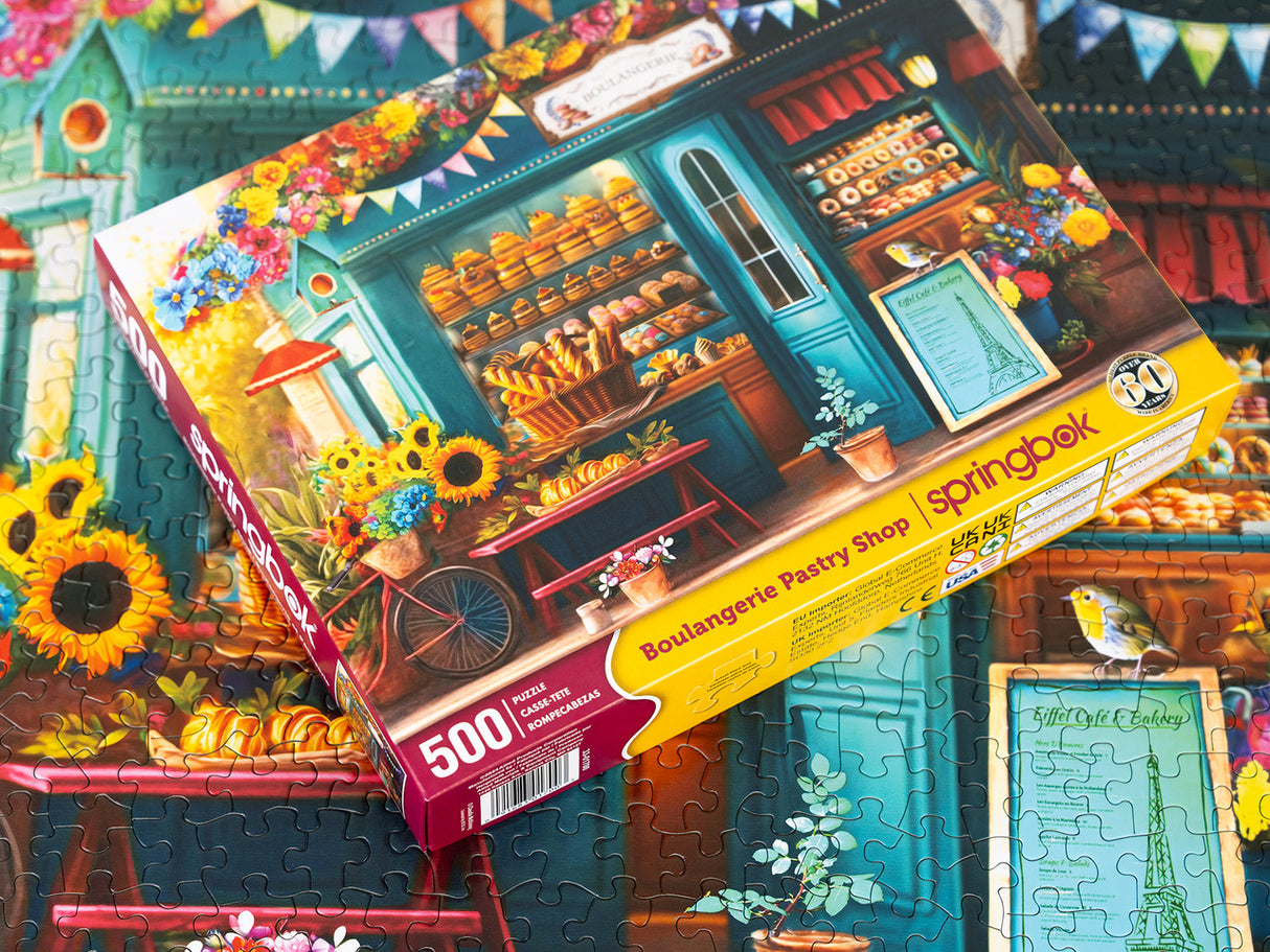 Box and Completed Puzzle Puzzle image of a charming Parisian boulangerie with fresh pastries and vibrant floral decor