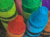 Close up of pieces for the Crayola Twist 500-piece jigsaw puzzle featuring vibrant colors