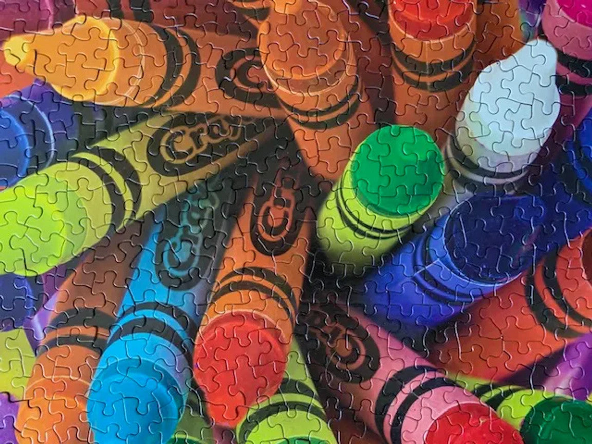 Close up showing pieces for the Crayola Twist 500-piece jigsaw puzzle featuring vibrant colors