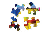 Close-up of Take Flight puzzle pieces from Springbok with bright hot air balloons and blue sky