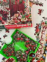 High-quality 500 piece jigsaw puzzle by Springbok featuring a cozy Christmas front door scene and sorting tray with puzzle pieces