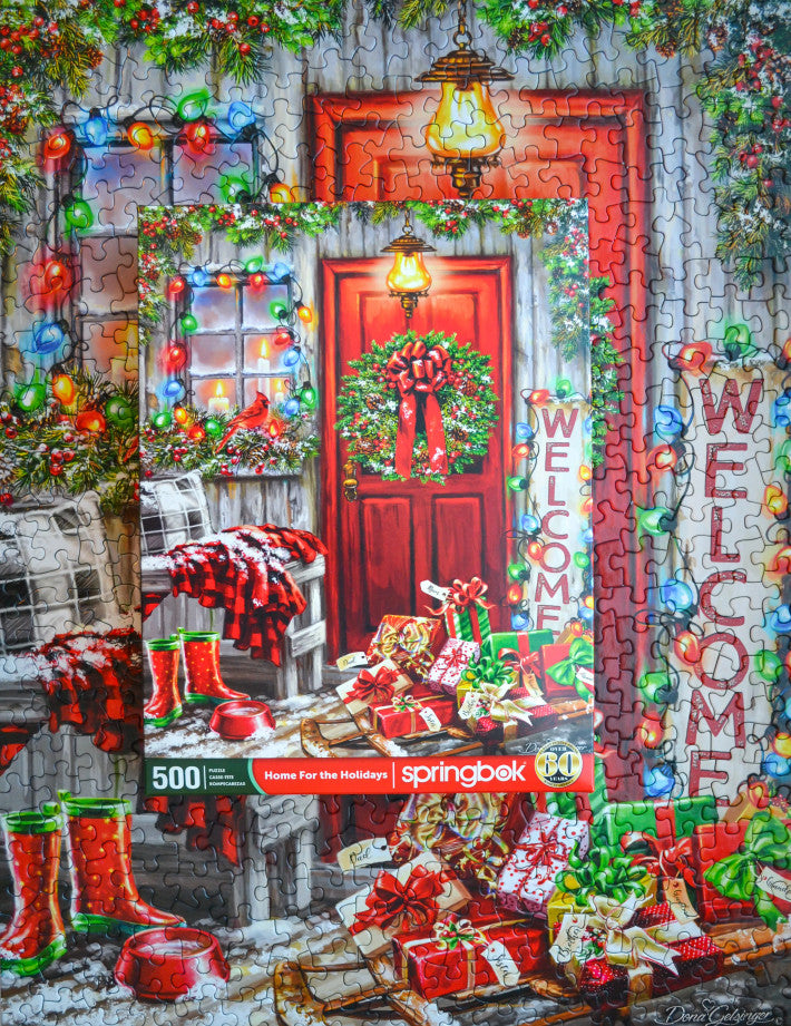 Completed Home for the Holidays puzzle by Springbok with charming holiday scene and sleigh full of presents