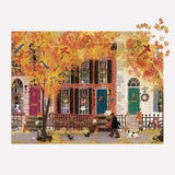 Galison puzzle of a fall-themed neighborhood scene with vibrant autumn colors