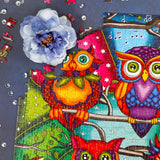 JaCaRou Puzzles' Owl Always Be There 1000-piece puzzle, depicting a whimsical collection of owls in various colors and patterns against a night backdrop.