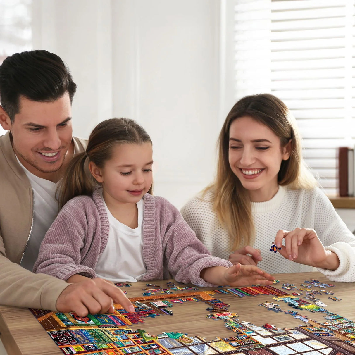 Family putting together the Boardwalk 1000-piece jigsaw puzzle showcasing a detailed scene of a lively bookstore