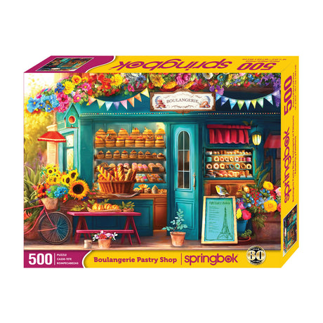 Box Springbok 500-piece jigsaw puzzle of a French bakery storefront filled with breads, cakes, and colorful macarons