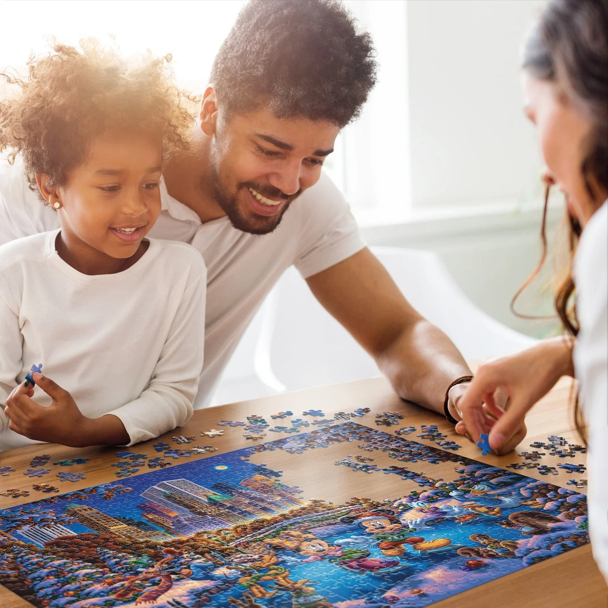 Family finishing the Disney and Dowdle Mickey & Friends Skating in Central Park 500 piece jigsaw puzzle