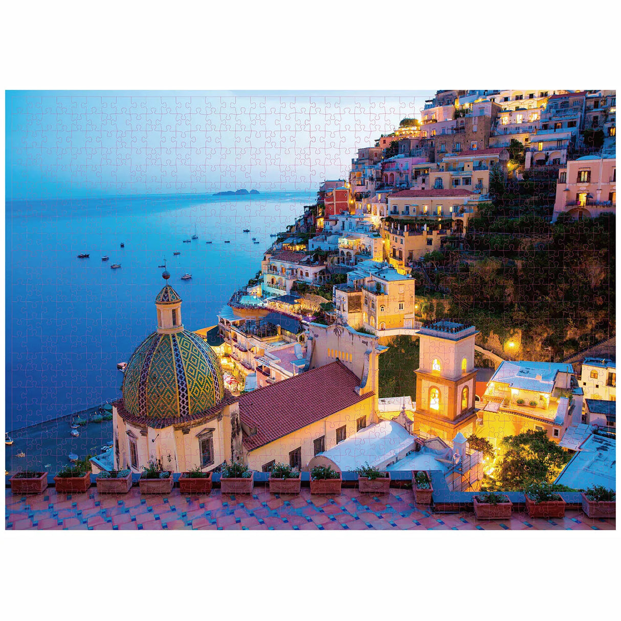 1000-piece Positano jigsaw puzzle featuring a stunning evening view of the colorful coastal town, with buildings cascading down the hillside towards the sea.
