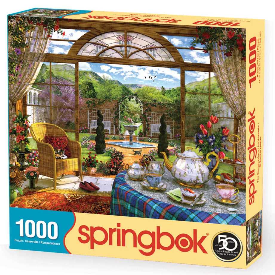 Box of The Conservatory puzzle featuring a garden view with a tea table, flowers, and a cozy chair by Springbok