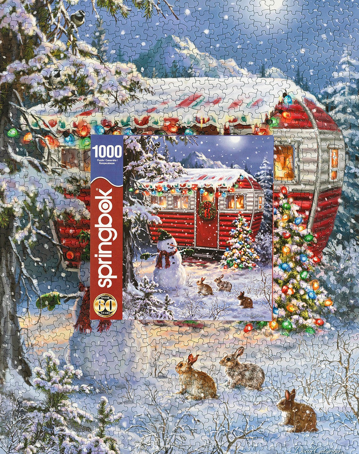 Box and Completed puzzle Springbok 1000-piece jigsaw puzzle of a cozy winter scene with a decorated Christmas tree and snowman