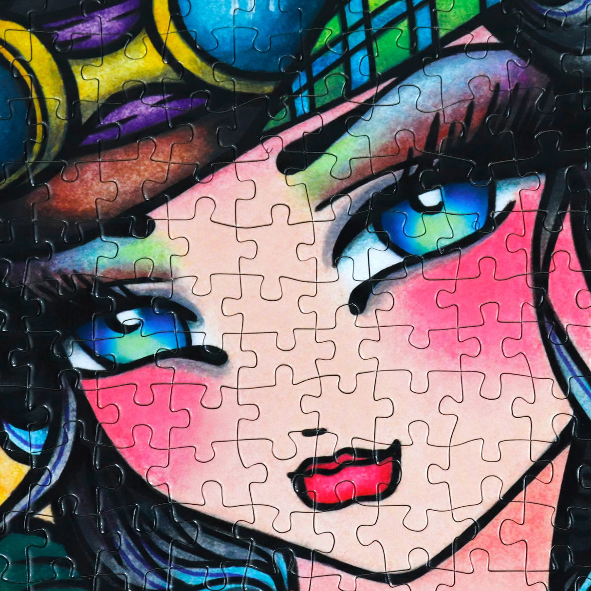 Close-up of JaCaRou Trixie jigsaw puzzle showing steampunk goggles and bright blue eyes