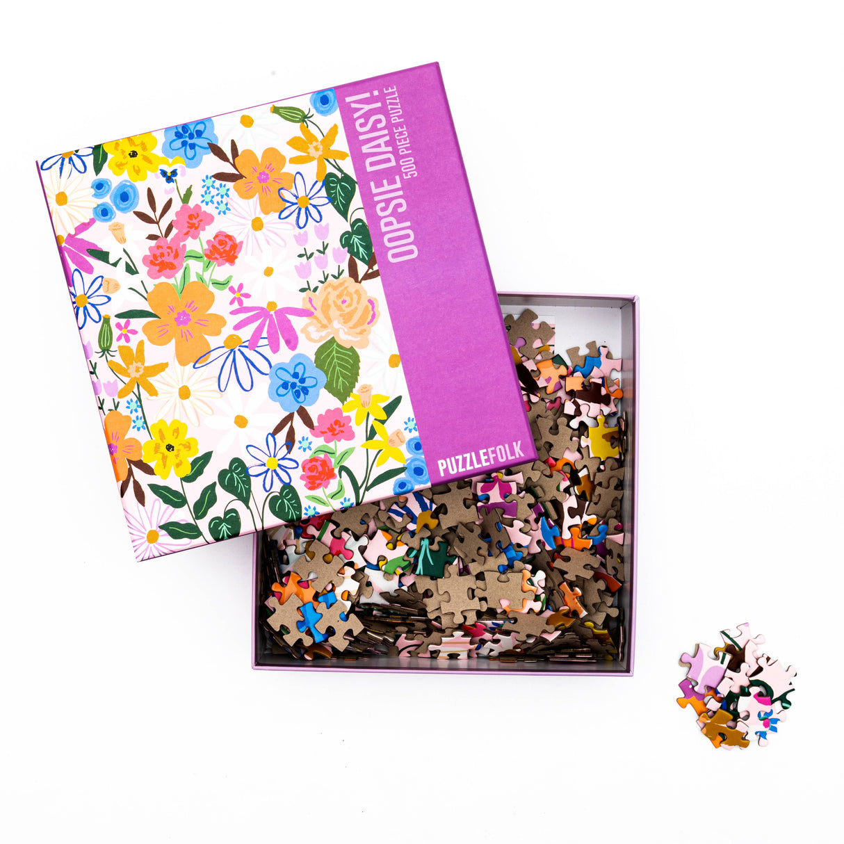 Oopsie Daisy jigsaw puzzle box featuring vibrant floral patterns